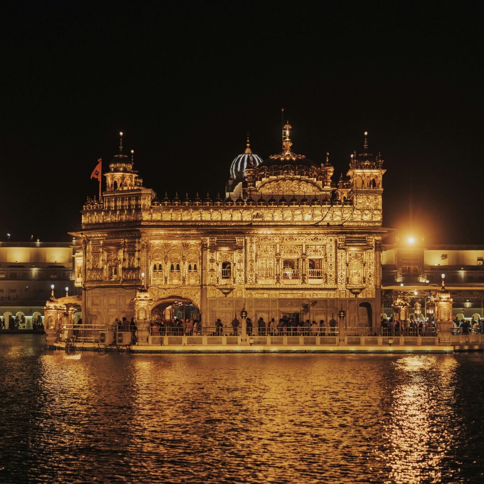 Stunning night view of the Golden Temple illuminated, reflecting in the Amrit Sarovar, Amritsar.